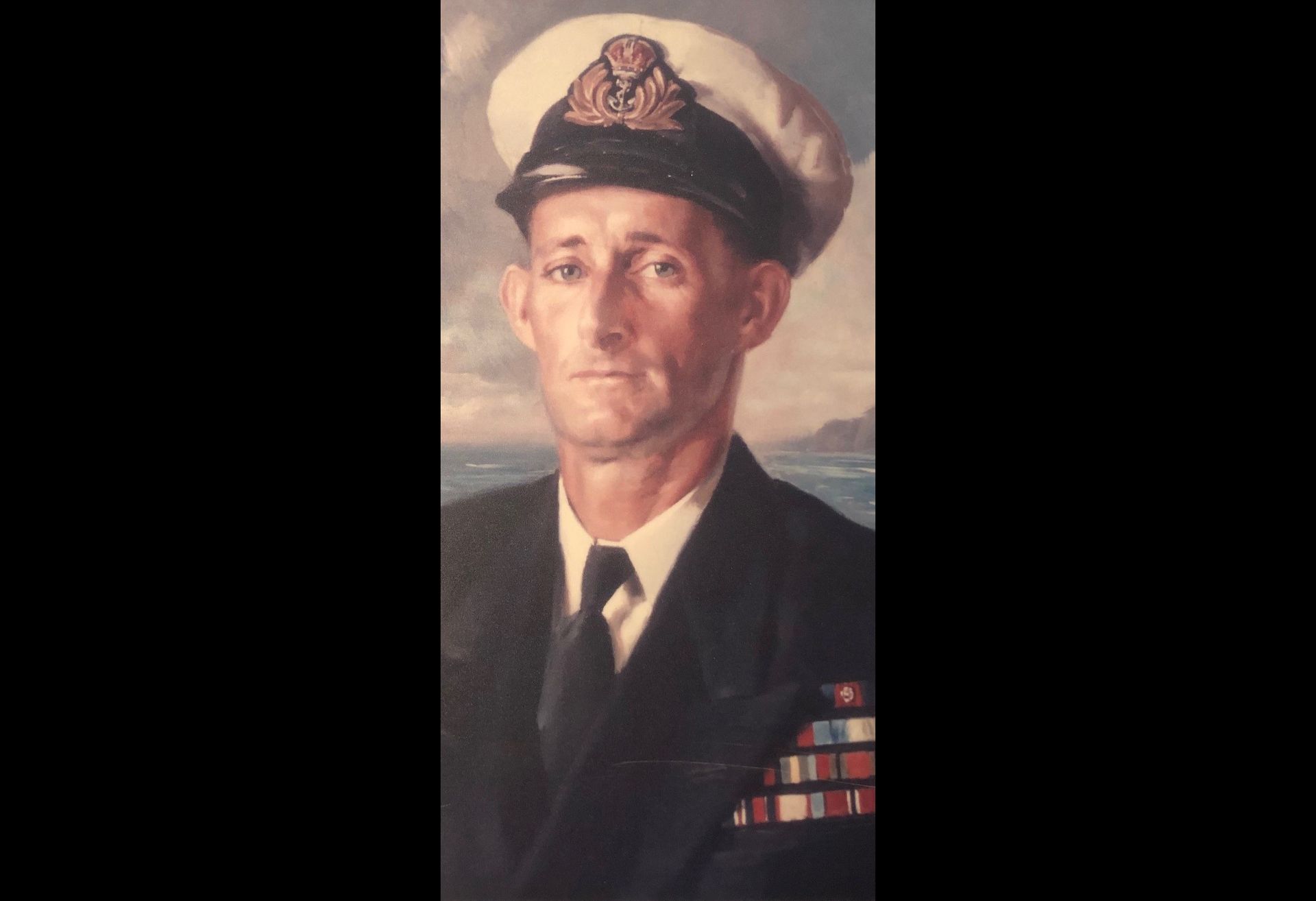 An oil painting of a sailor in a dark suit and tie and dress hat, the sea in the background.